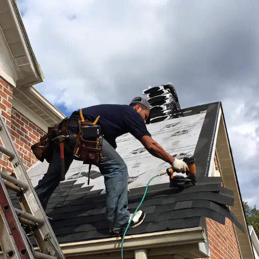A full color 512x512 webp image of a CAT Exteriors roofing specialist installing a roof.