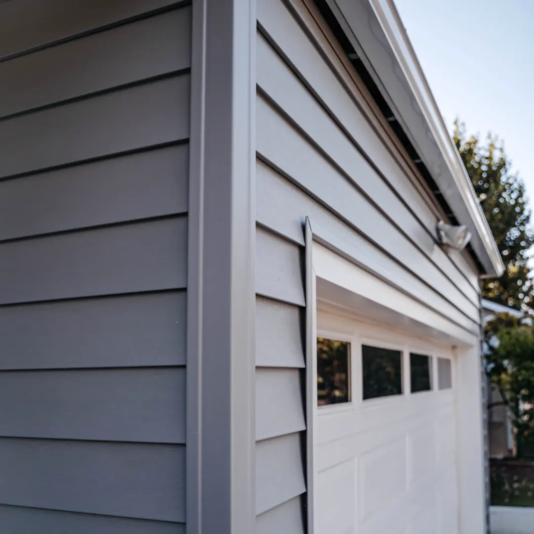 A full color 1080x1080 webp image of a home with newly installed vinyl siding by CAT Exteriors.