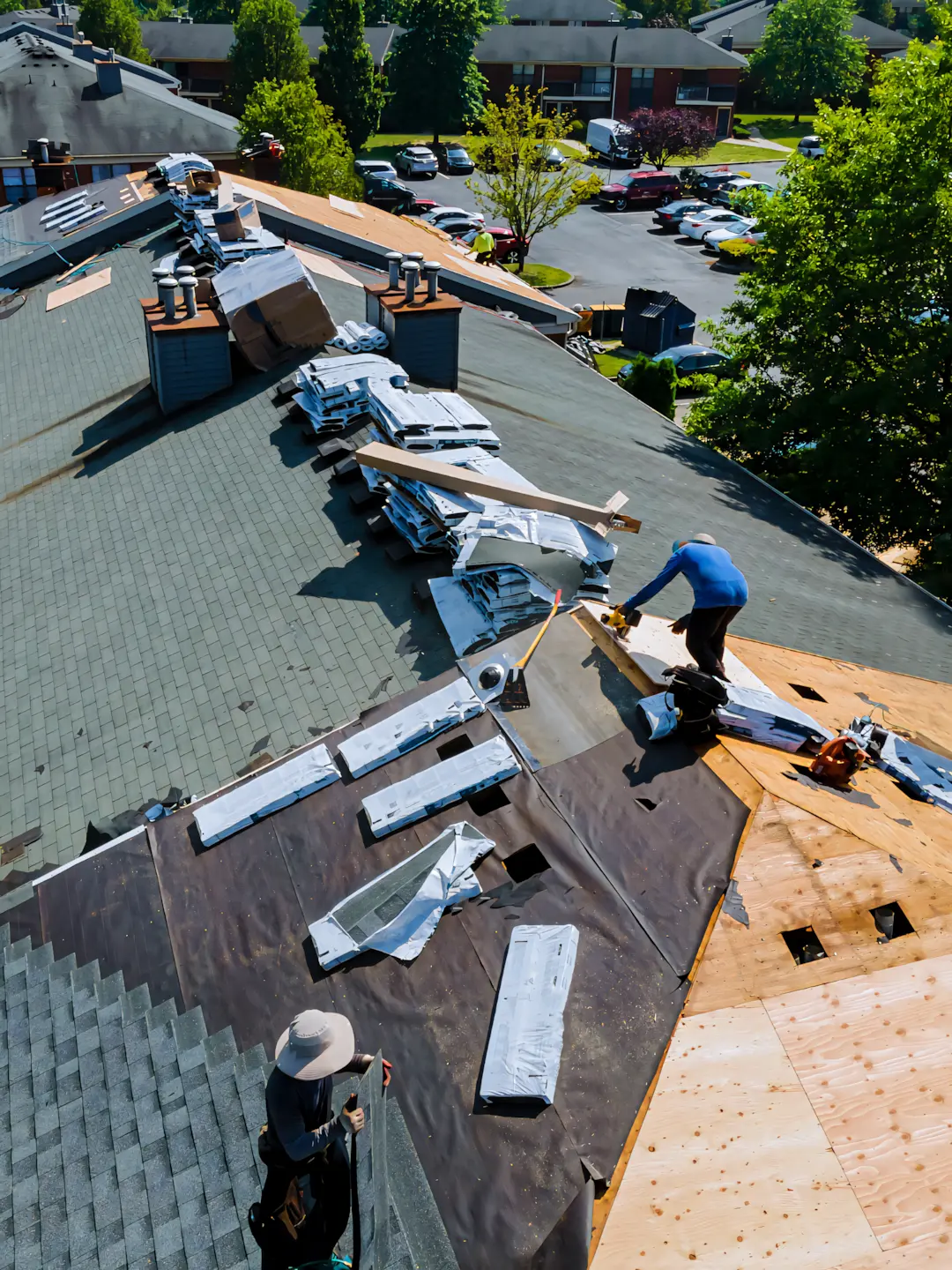 A full color 1080x1440 webp image of CAT Exteriors roofers installing shingles on a client's home.