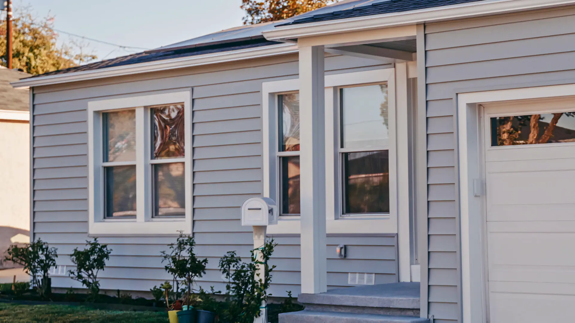 A full color 1920x1080 webp image of a finished home exterior with CAT Exteriors siding.