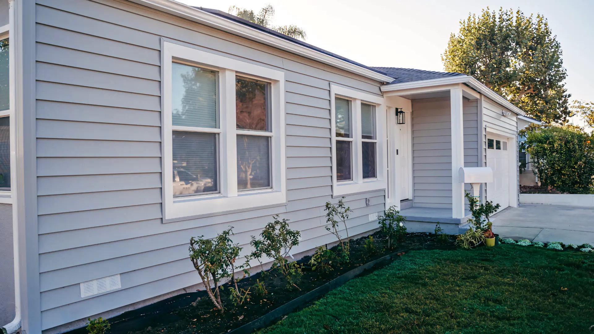 A full color 1920x1080 webp image of a completed vinyl siding home by CAT Exteriors.