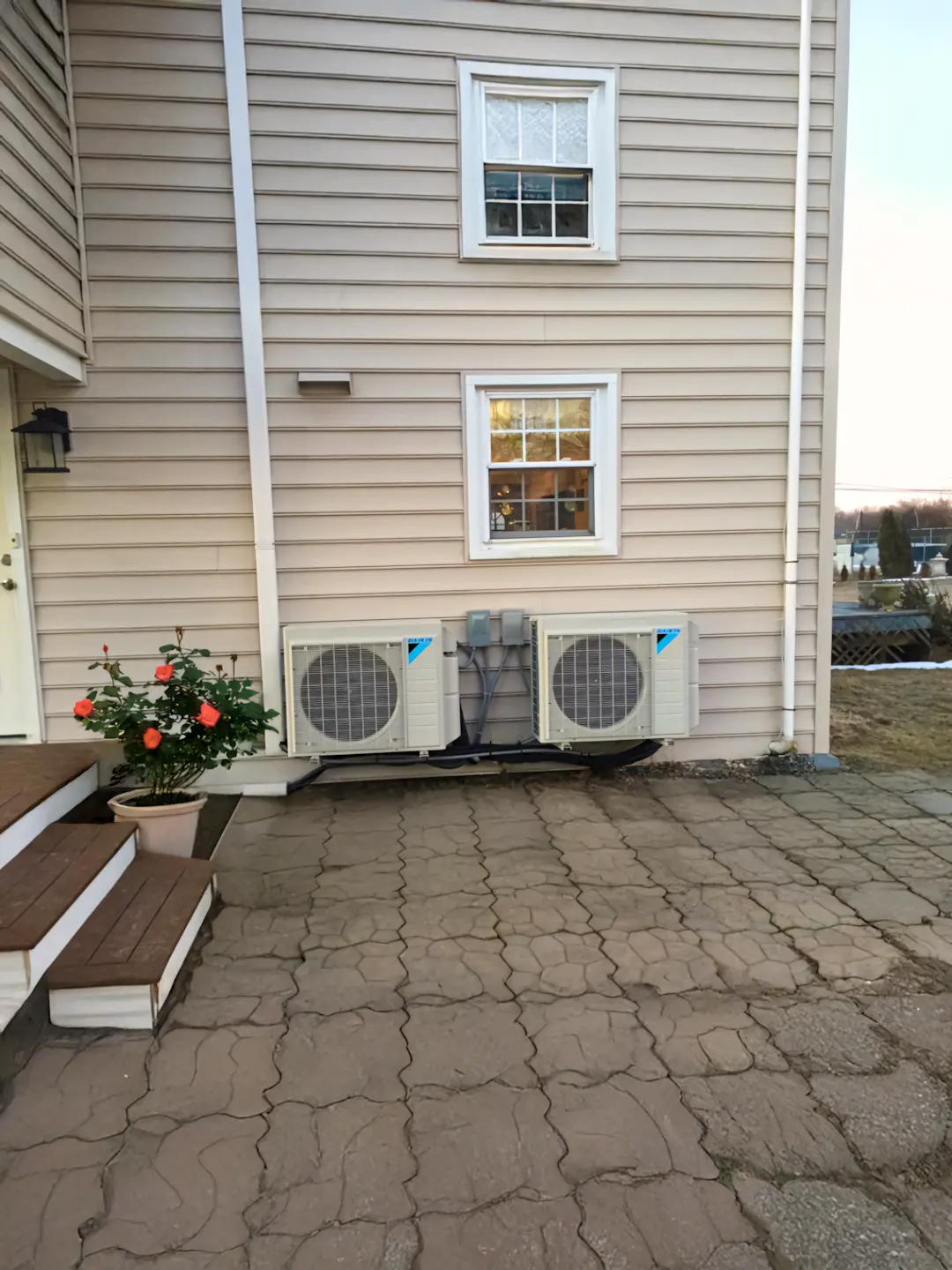 A full color 1080x1440 webp image showing two wall mounted mini–split AC units installed by CAT Exteriors.
